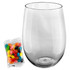 A clear plastic cup with a rounded base beside a bag of multicoloured jelly beans.