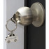 A silver key ring shaped like a car hangs from a door knob, featuring a logo.
