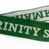 A green woven lanyard with white text, featuring a logo or branding on its surface.