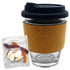 A glass coffee cup with a cork band, accompanied by a mixed bag of colourful jelly lollies.