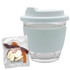 A glass coffee cup with a light blue silicone sleeve, accompanied by a pack of mixed jelly lollies in various colours.
