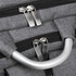 A grey laptop backpack with dual zippers and a silver handle. It has a textured fabric and features branding.