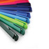 A collection of plastic pens in vibrant colours, including pink, purple, blue, green, and dark blue, with a logo.