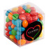 A clear cube filled with chewy fruit candies in vibrant colours: red, orange, yellow, green, and blue.