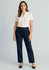 A woman stands wearing a white shirt and navy relaxed pants. The outfit features a logo on the pants.