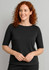 A black short sleeve T-shirt featuring a round neckline, worn by a woman with curly red hair.