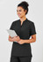 A black women's tunic with a short collar and pockets, featuring a model holding a clipboard.