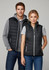 A black women's vest with a zip front and pockets, modelled by a woman and a man wearing casual clothing.