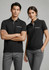 A black short sleeve polo shirt for women features a front pocket and is paired with grey trousers. It has a logo.