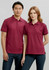 A burgundy women's short sleeve polo shirt with a collar, featuring a logo, styled on a model.