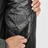 A close-up of a men's thermal jacket in dark green, displaying the inner lining and a label with brand information.
