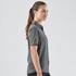 A women's short-sleeve button-up shirt in grey, featuring a sleek design and a logo on the fabric.