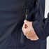 A close-up of a navy rain jacket featuring a zippered pocket and hand adjusting the zipper.