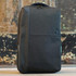A sleek black backpack with a textured finish and a branding logo on the front.
