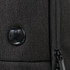 A black backpack featuring a textured surface and a round logo. The zipper detail is also visible.