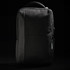 A sleek black backpack with a textured finish and a subtle logo, featuring zippered compartments and a sturdy handle.