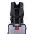 A black Swissdigital Pixel Backpack is attached to a silver trolley suitcase, featuring adjustable straps and a logo.