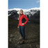 A red and black women's softshell jacket is featured on a model standing in a mountainous landscape.