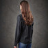 A black button-up shirt with long sleeves, seen from the back, worn by a woman with long hair.
