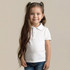 A child wearing a plain white polo shirt, with long hair styled in pigtails, standing against a neutral background.