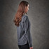 A grey women's long-sleeve t-shirt featuring a fitted design and soft fabric, with a logo on the front.