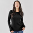 A black crew neck shirt featuring long sleeves, worn by a model. The shirt has a subtle ribbed texture and a logo.