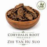 Yan Hu Suo (Corydalis yanhusuo) dried prepared root slices displayed in an elegant wooden bowl on a white background, lab-tested traditional Chinese herb used in Traditional Chinese Medicine.