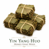 Bundled Yin Yang Huo (Honey Goat Weed) leaves tied into neat square bundles and displayed on a white background, showing the traditional presentation of whole dried Epimedium herb.