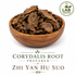 Yan Hu Suo (Corydalis yanhusuo) dried prepared root slices displayed in an elegant wooden bowl on a white background, lab-tested traditional Chinese herb used in Traditional Chinese Medicine.