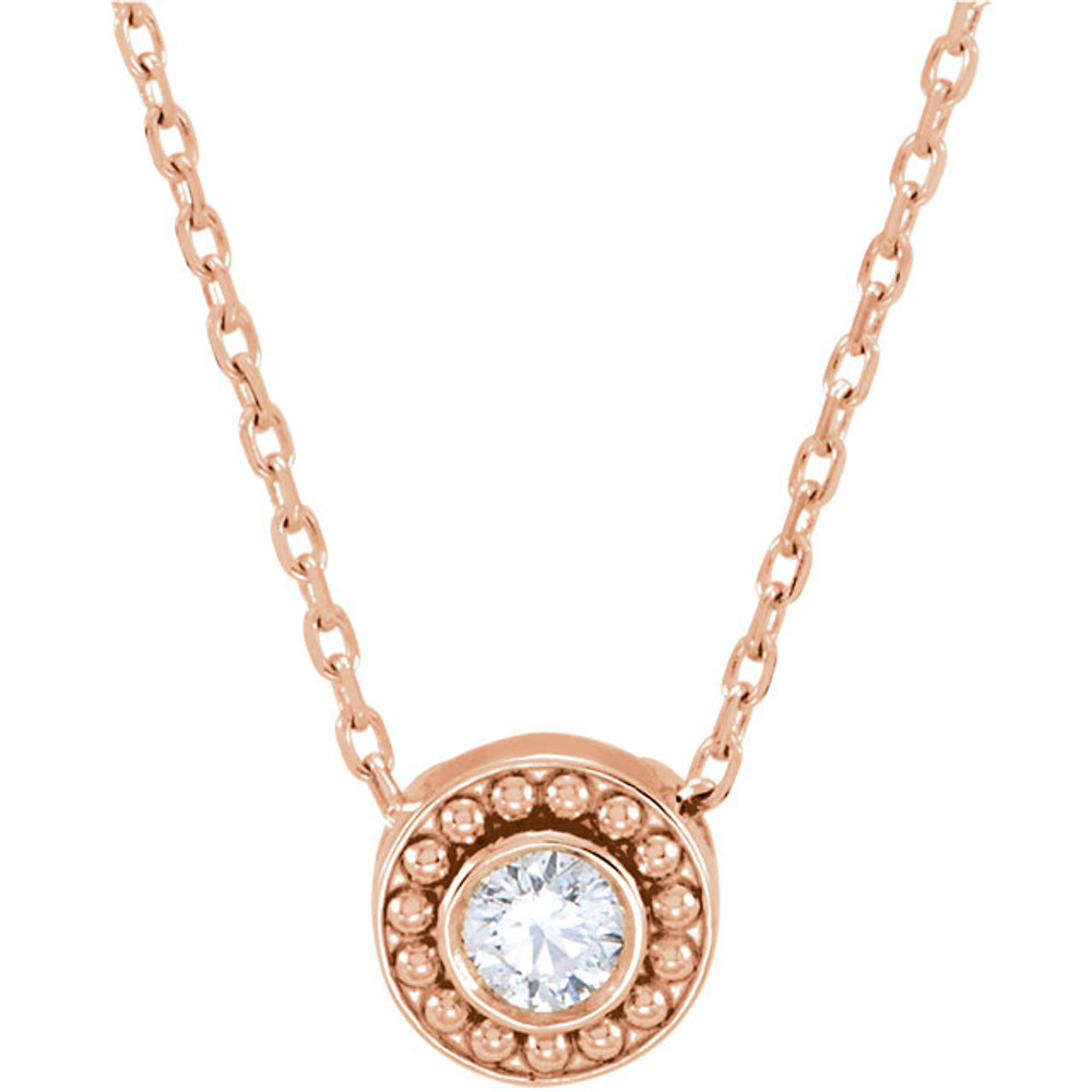 The 14k gold necklace features a round, sliding pendant with a 1/10ctw diamond in the center that is wreathed by the classic column beading. 