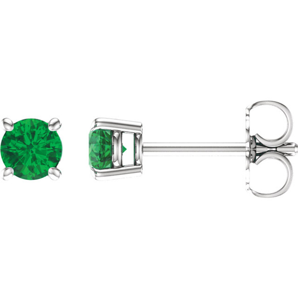 Delicate in design, these petite emerald stud earrings feature a pair of hand-selected classic green emeralds complemented by 14k white gold four-prong settings.