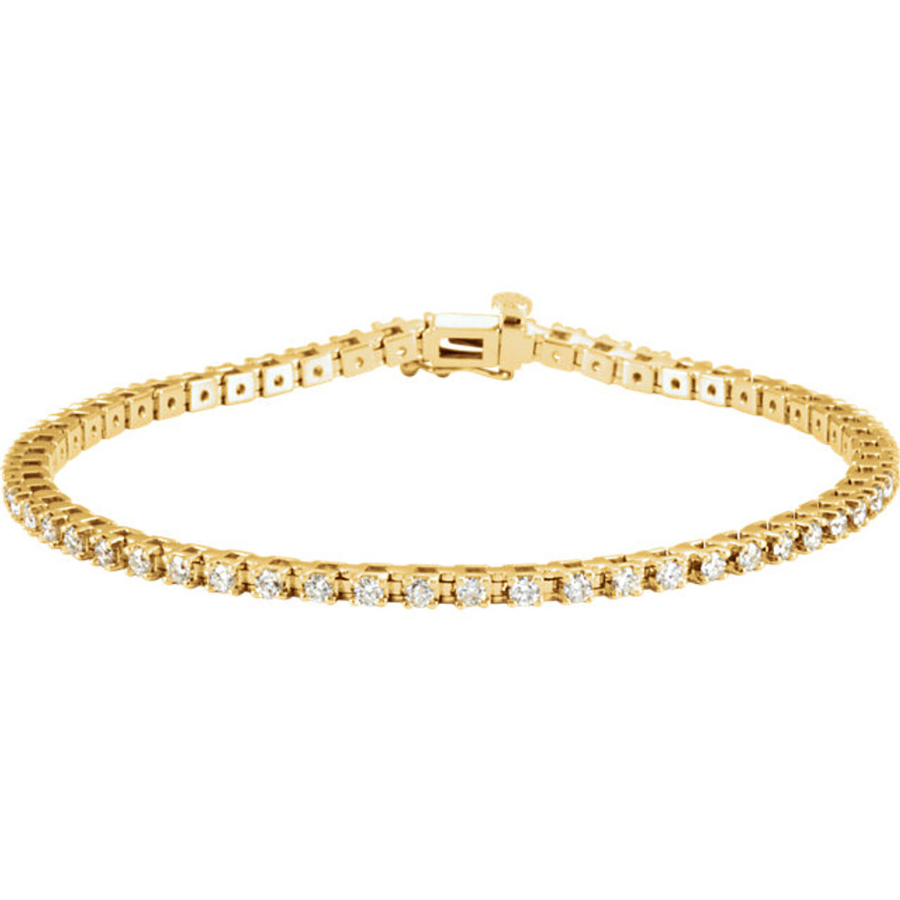 Sparkling, brilliant cut diamonds are set in a classic 14k yellow gold, four-prong 7.25" tennis bracelet.