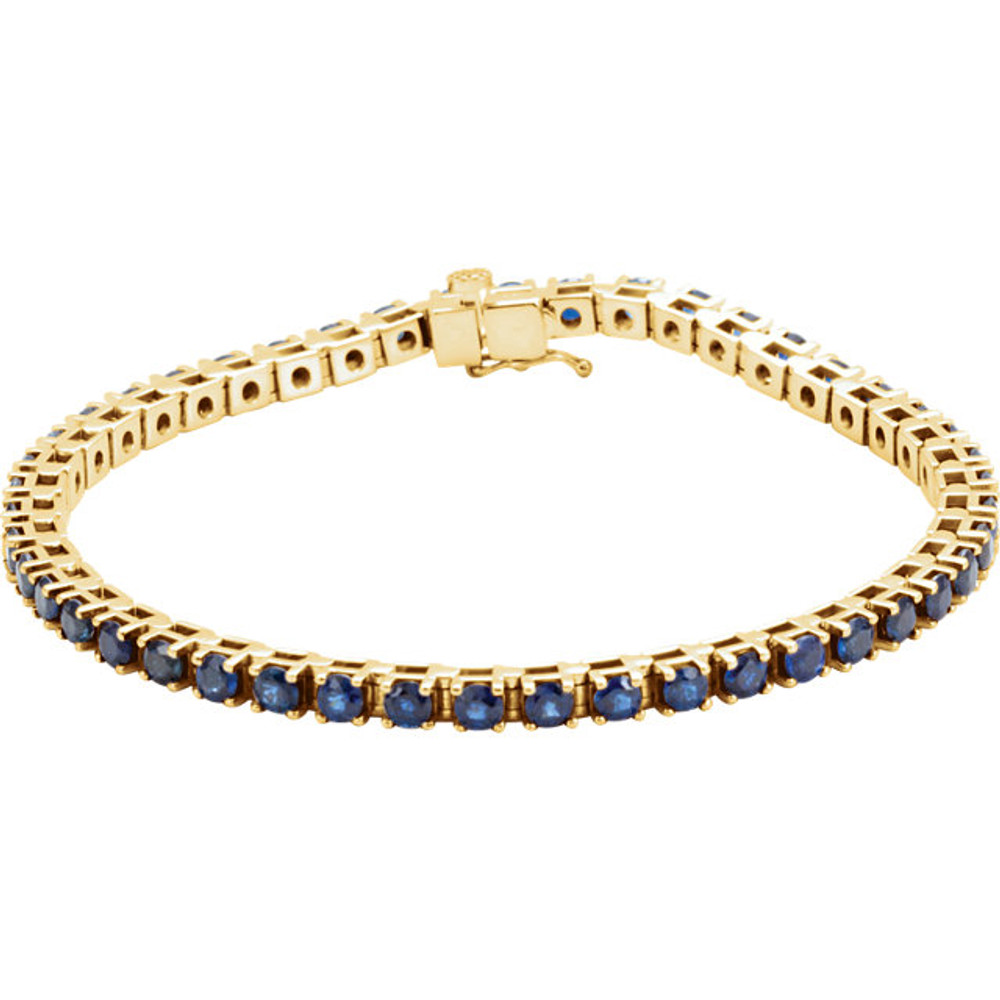 Striking in design, this petite sapphire 7.00" bracelet features 46 rich blue sapphires set in 14k yellow gold with a box catch clasp and hidden safety.