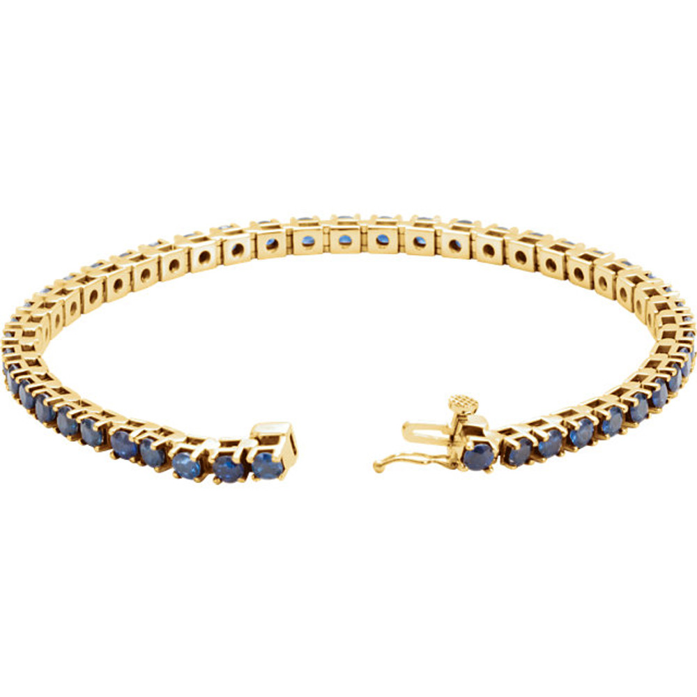 Striking in design, this petite sapphire 7.00" bracelet features 46 rich blue sapphires set in 14k yellow gold with a box catch clasp and hidden safety.