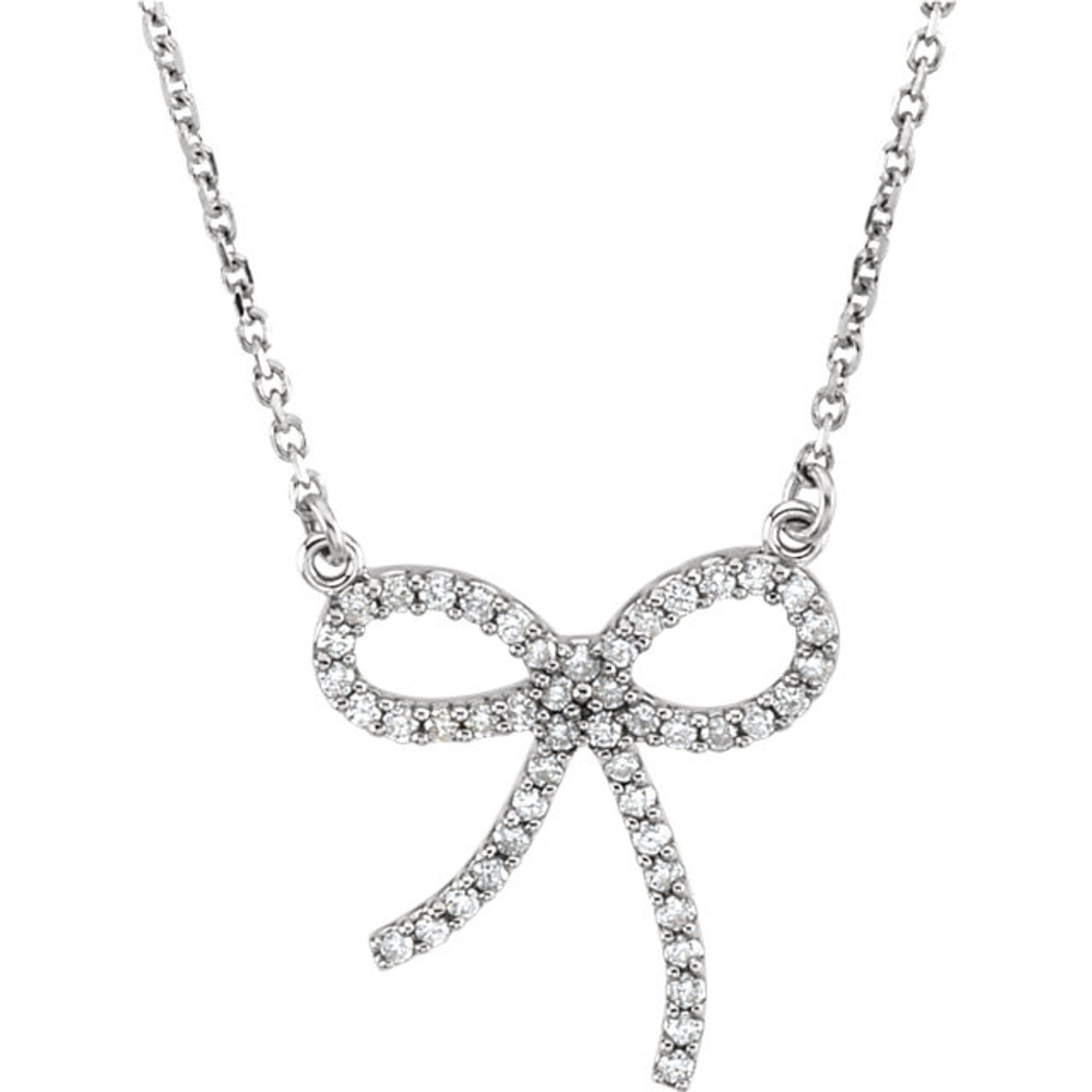 Wonderful 14Kt white gold diamond bow design necklace with a total diamond carat weight of 1/4cts. hanging from a necklace with a length of 16" inches. Total weight of the gold is 2.41 grams.