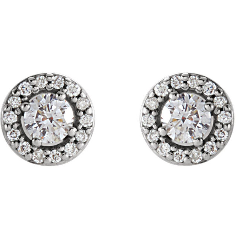 A classic pair of diamond halo earrings featuring 2 center round brilliant diamonds along with 28 sparkling white round side diamonds weighing . 0.25 carats! A beautifully styled setting crafted in 14K white gold. A great size for everyday wear with brilliant sparkle and no visible inclusions. The center diamonds grade with Color G-H, Clarity I1 while the side diamonds grade with an color G-H, clarity I1. The earrings present a spectacular value and offer a big, fiery look. A very good value for big diamonds in a halo setting. A must have style!