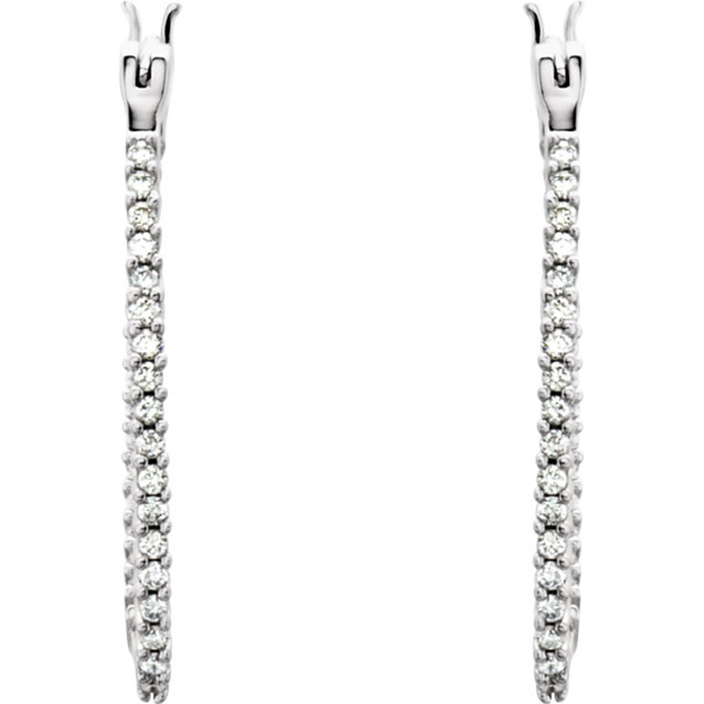 Superb style is found in these 14Kt white gold hoop earrings accented with the brilliance of round full cut diamonds. Total weight of the diamonds is 1/2 carat. 