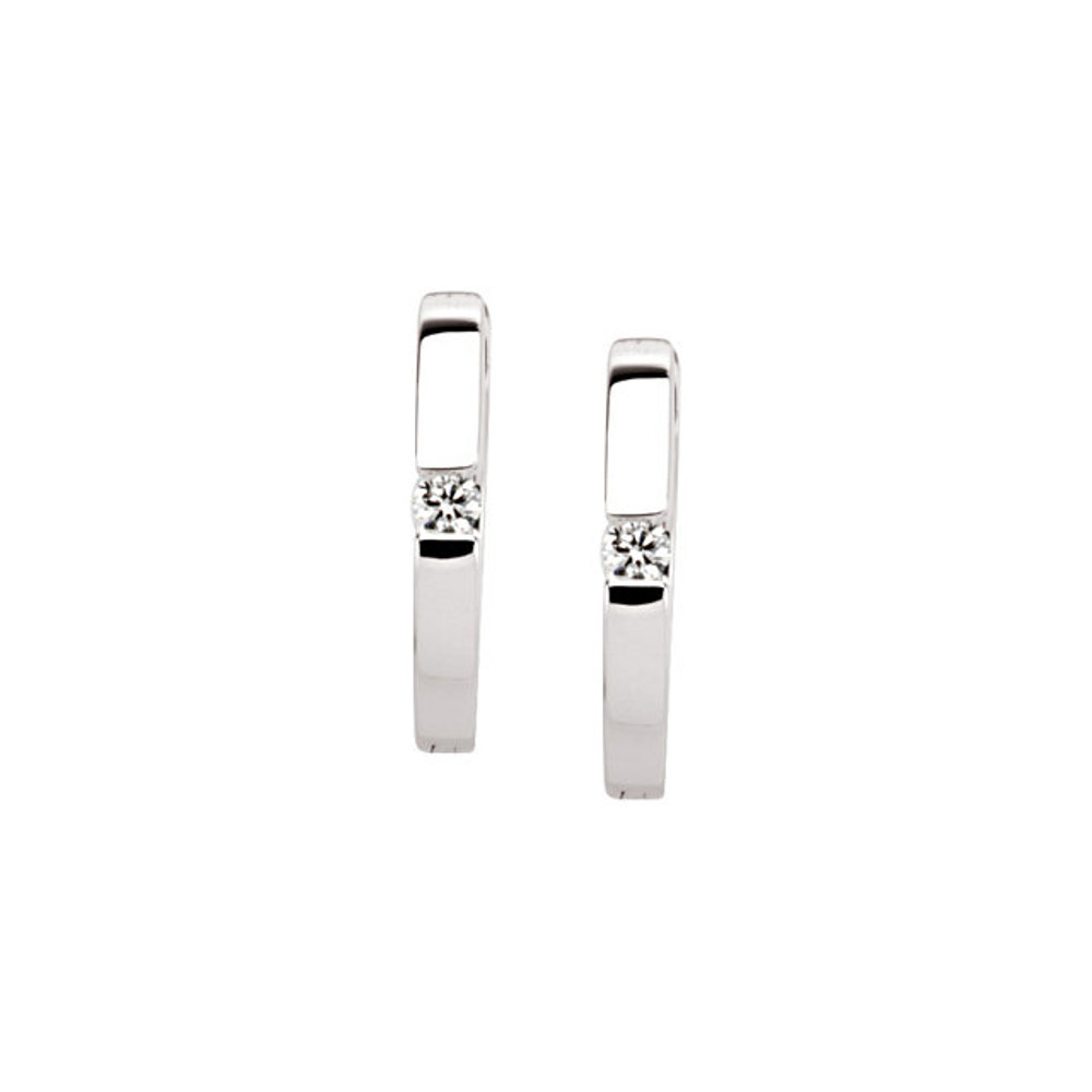 Brilliant round cut diamond adorn these petite hoop earrings in 14k white gold. A versatile look for evening or everyday wear.