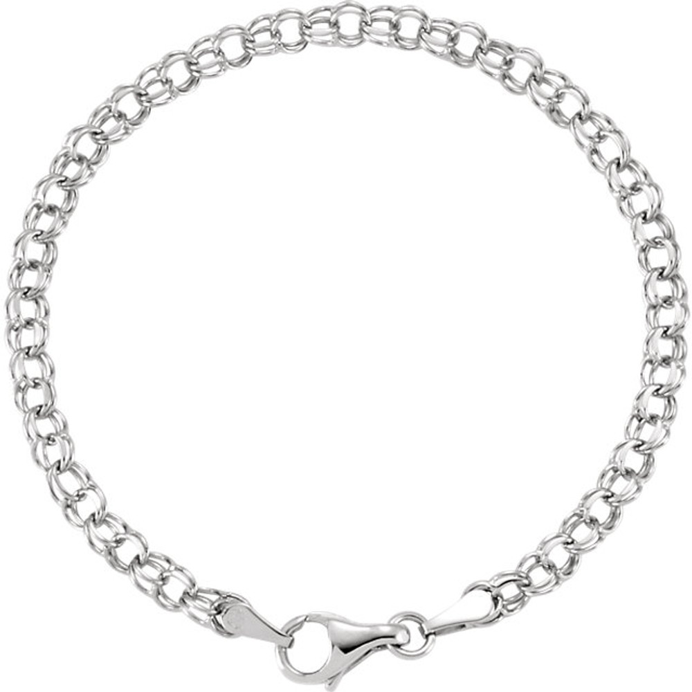 Classic, solid 14K white gold charm bracelet is seven inches in length and is approximately 1/8th inch wide. The bracelet is made in the double curb style. It is connected with a sturdy lobster claw clasp.