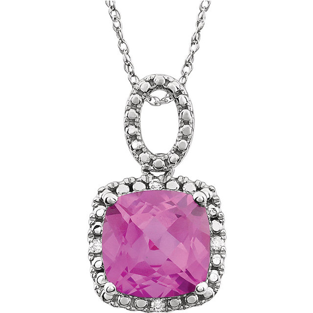 Exquisite 14Kt white gold pendant captures the beauty of a genuine 9.00mm cushion cut created pink sapphire accented by white shimmering diamonds hanging from an 18" inch chain. Total weight of the diamonds is 0.03 total carat weight.