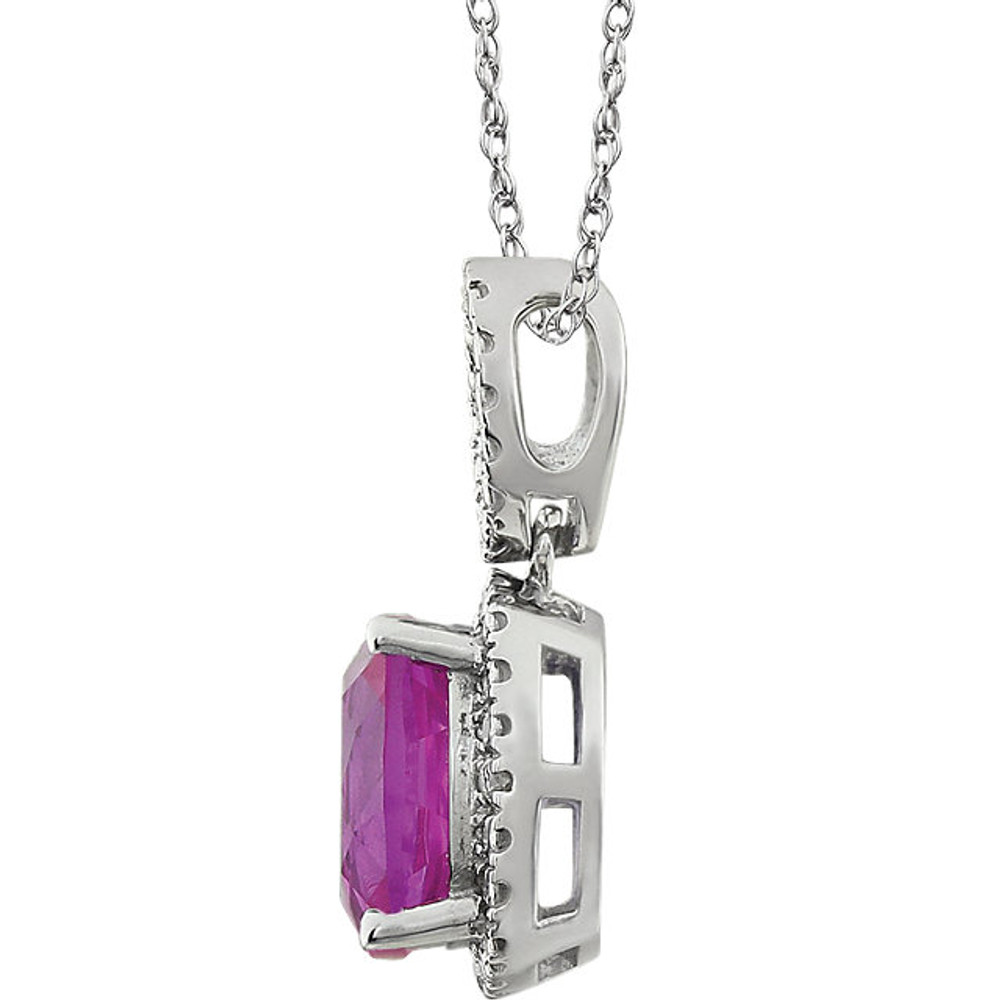 Exquisite 14Kt white gold pendant captures the beauty of a genuine 9.00mm cushion cut created pink sapphire accented by white shimmering diamonds hanging from an 18" inch chain. Total weight of the diamonds is 0.03 total carat weight.