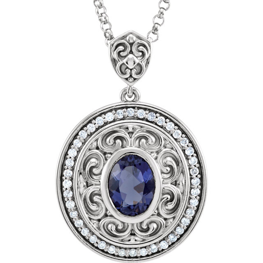 A Beautiful Bezel Set 8.00 x 6.00 mm Iolite Gemstone is Surrounded by Finely Wrought 14k White Gold Scroll Designs in This Medallion Pendant. 40 Inlaid Diamonds Create a Stunning Halo Frame.