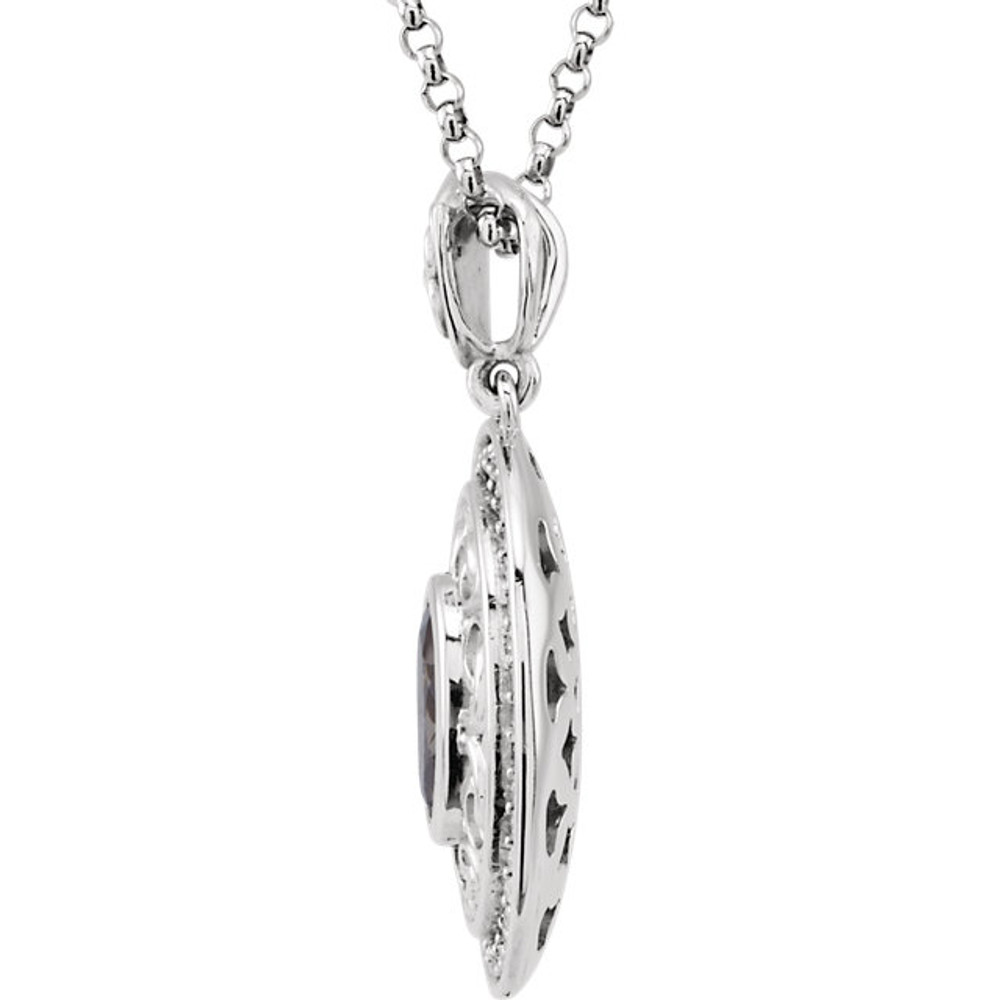 A Beautiful Bezel Set 8.00 x 6.00 mm Iolite Gemstone is Surrounded by Finely Wrought 14k White Gold Scroll Designs in This Medallion Pendant. 40 Inlaid Diamonds Create a Stunning Halo Frame.