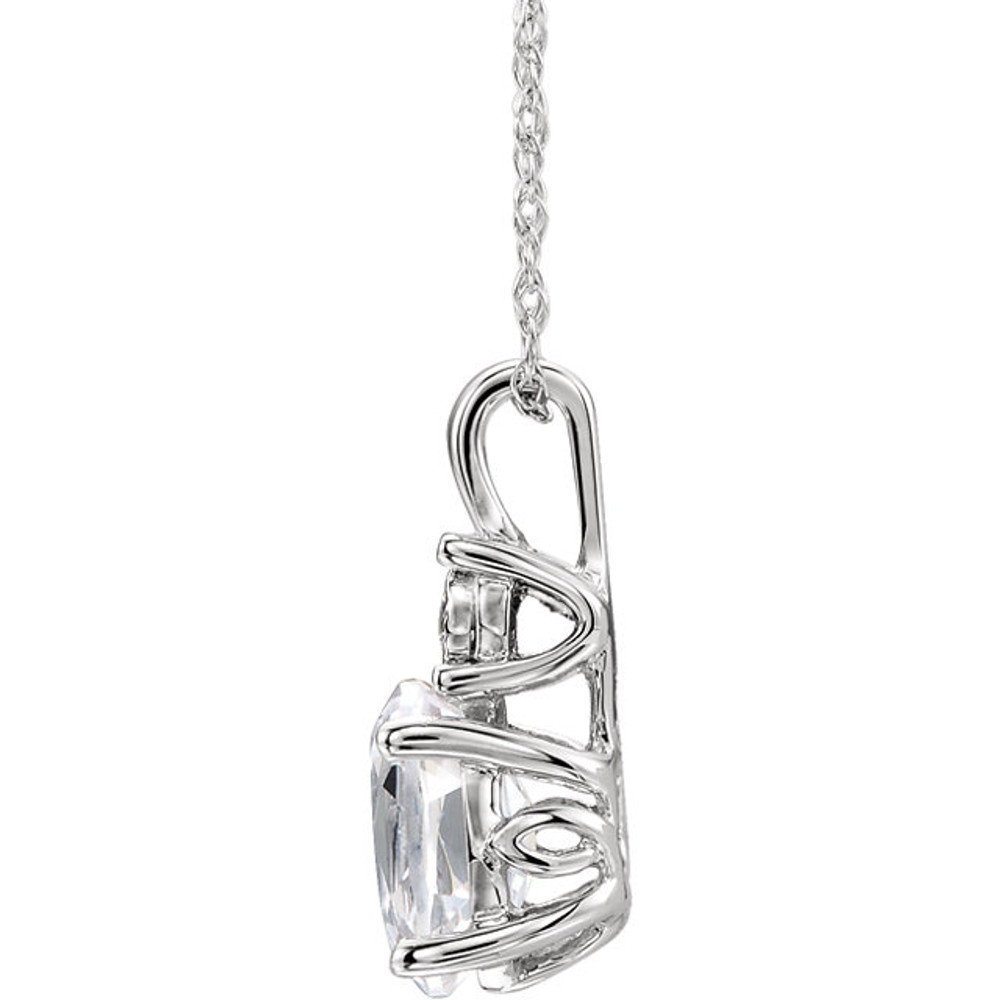 Exquisite 14Kt white gold pendant captures the beauty of a genuine 7x5mm oval Created White Sapphire accented by white shimmering diamonds hanging from an 18" inch necklace. Total weight of the diamonds is 0.02 total carat weight.