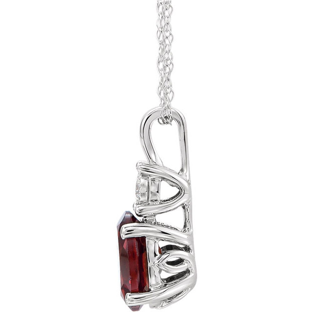 Exquisite 14Kt white gold pendant captures the beauty of a genuine 7x5mm oval Mozambique Garnet accented by white shimmering diamonds hanging from an 18" inch necklace. Total weight of the diamonds is 0.02 total carat weight.