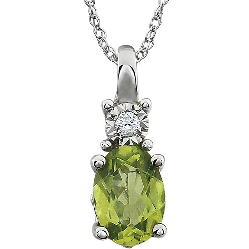 Exquisite 14Kt white gold pendant captures the beauty of a genuine 7x5mm oval Peridot accented by white shimmering diamonds hanging from an 18" inch necklace. Total weight of the diamonds is 0.02 total carat weight.