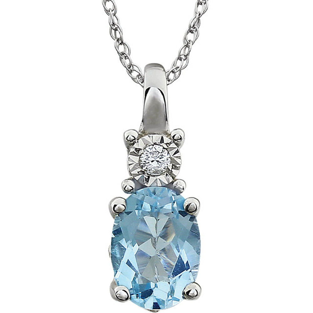 Exquisite 14Kt white gold pendant captures the beauty of a genuine 7x5mm oval sky blue topaz accented by white shimmering diamonds hanging from an 18" inch necklace. Total weight of the diamonds is 0.02 total carat weight.