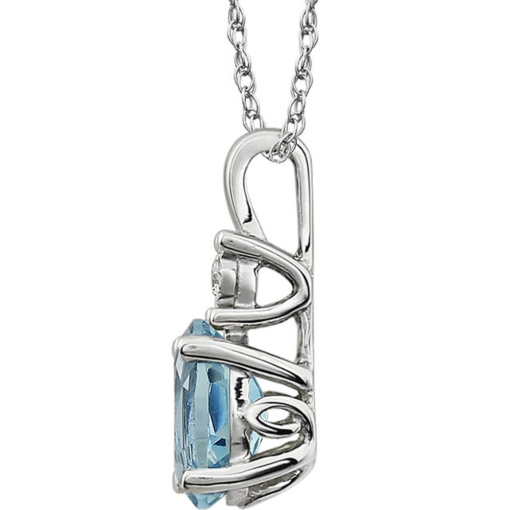 Exquisite 14Kt white gold pendant captures the beauty of a genuine 7x5mm oval sky blue topaz accented by white shimmering diamonds hanging from an 18" inch necklace. Total weight of the diamonds is 0.02 total carat weight.