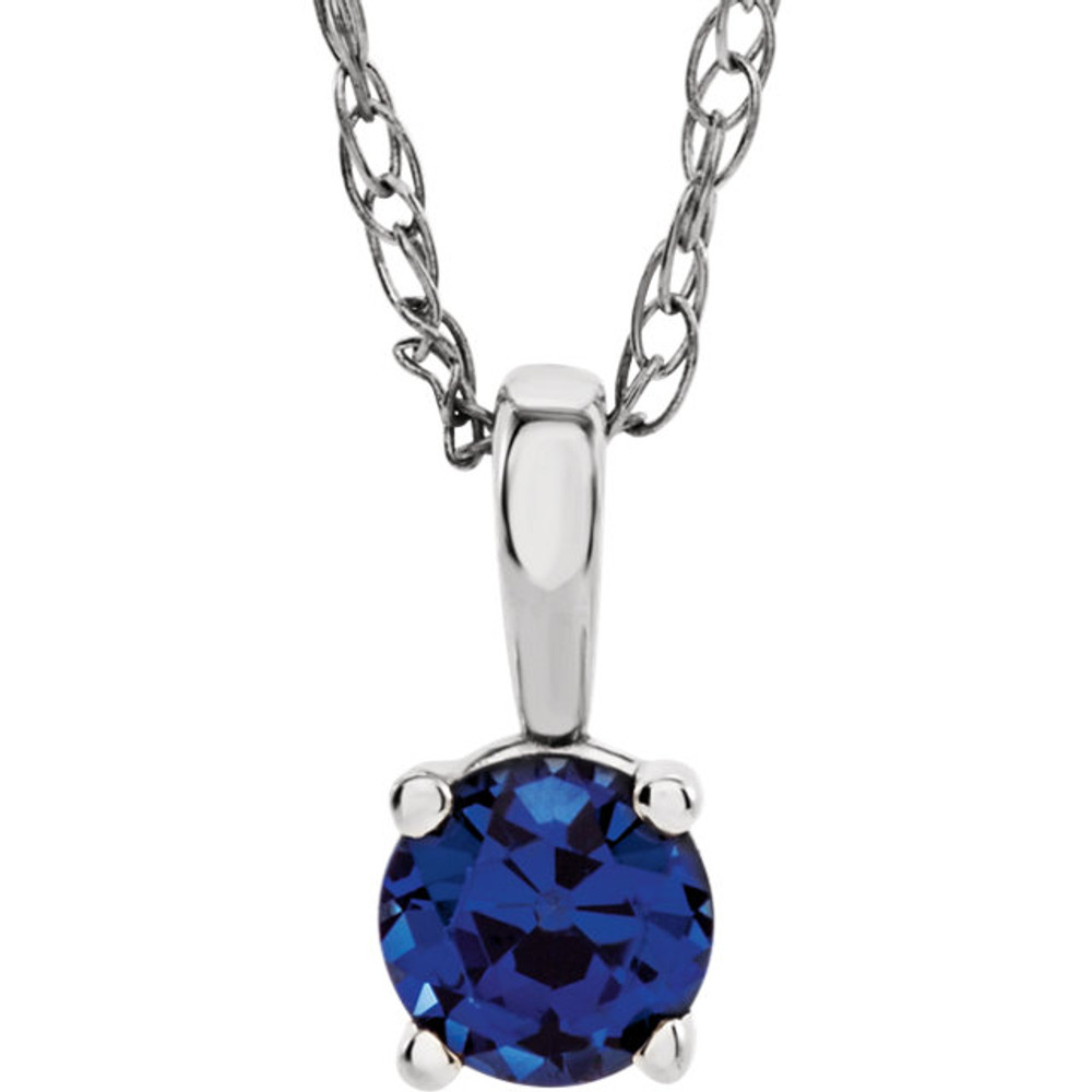 This gorgeous 14K white gold pendant features a 3mm created Blue Sapphire beautifully set in a prong setting. Symbolize your love with this elegant September birthstone pendant!
