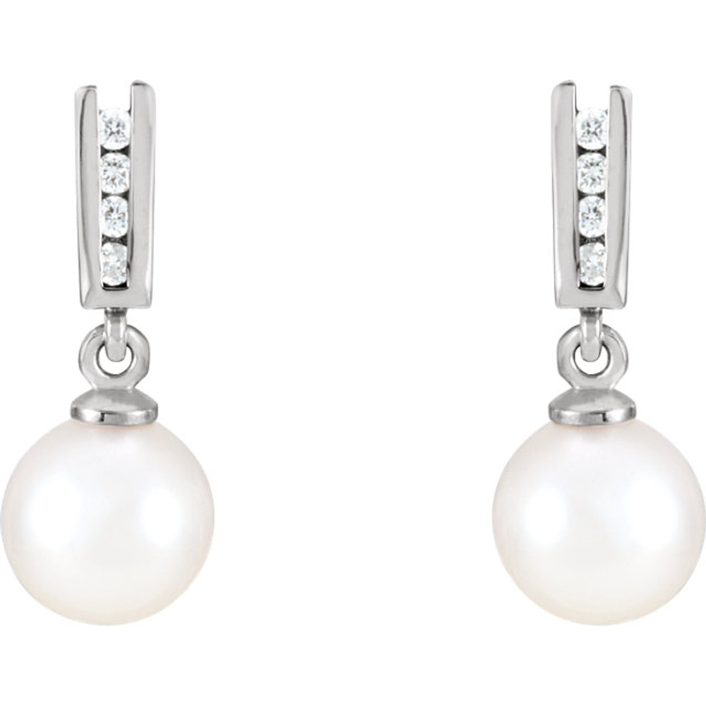 Beautiful 14k white gold earrings featuring 7.50mm pearls and 1/8 carats in white diamonds. Total weight of the gold is 1.59 grams.